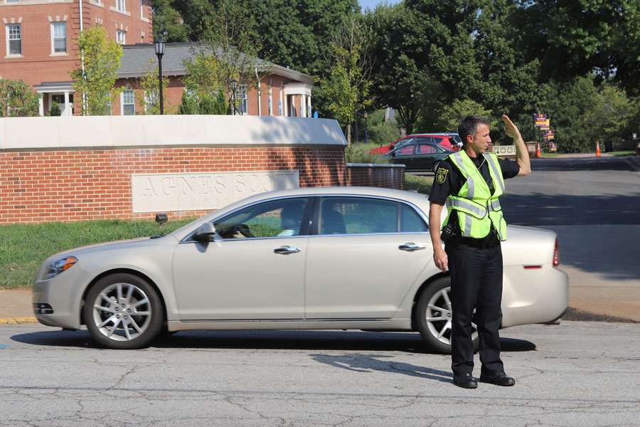 A public safety officer directs traffic.